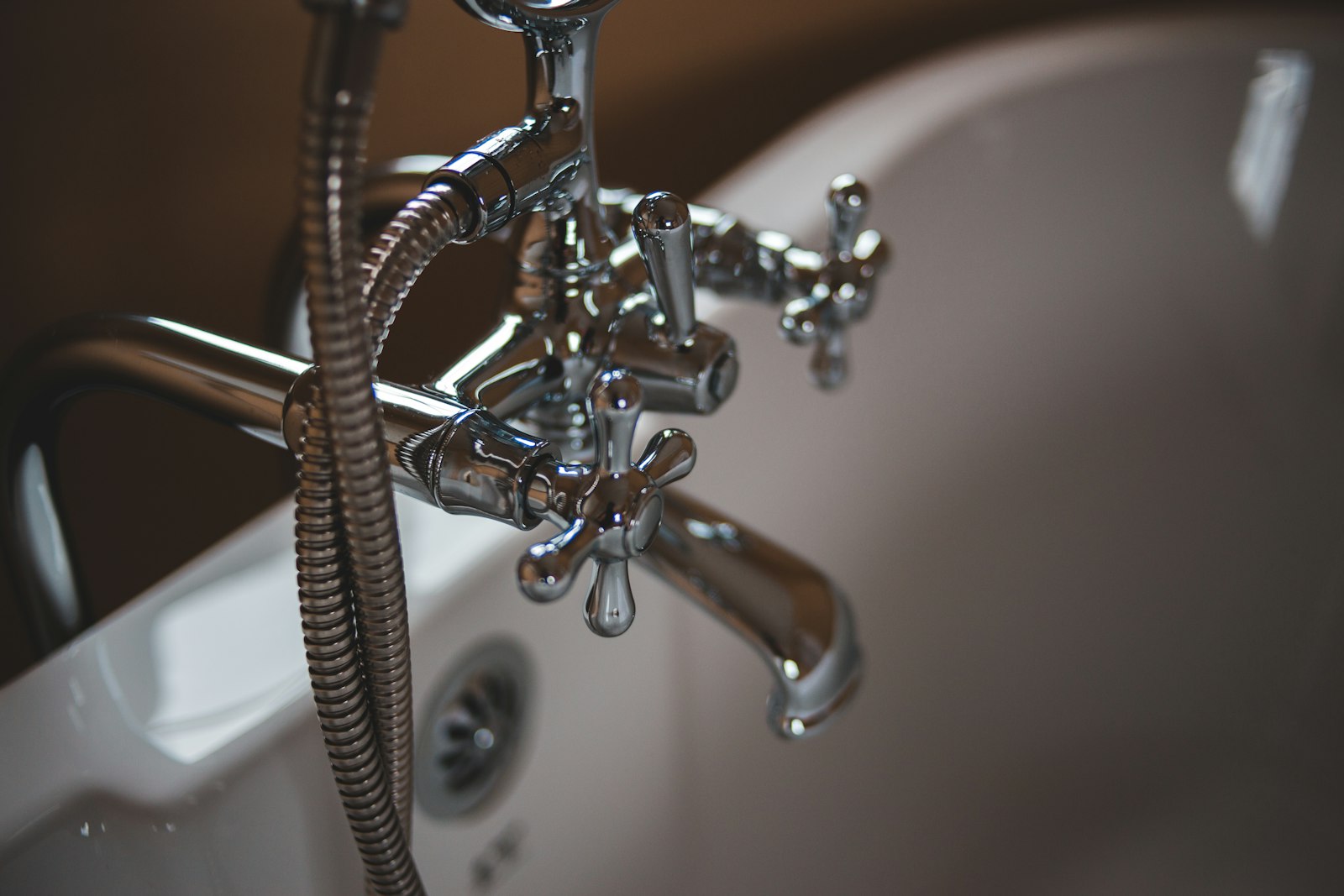 Vintage chrome bath fittings in warm low light