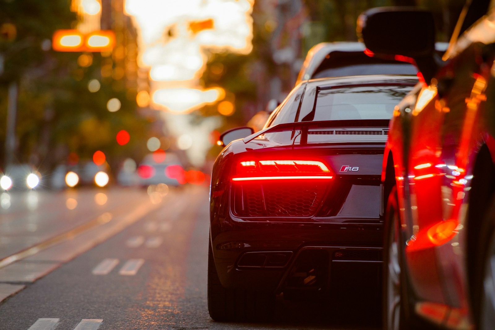 Tail light glowing on a dusk city street
