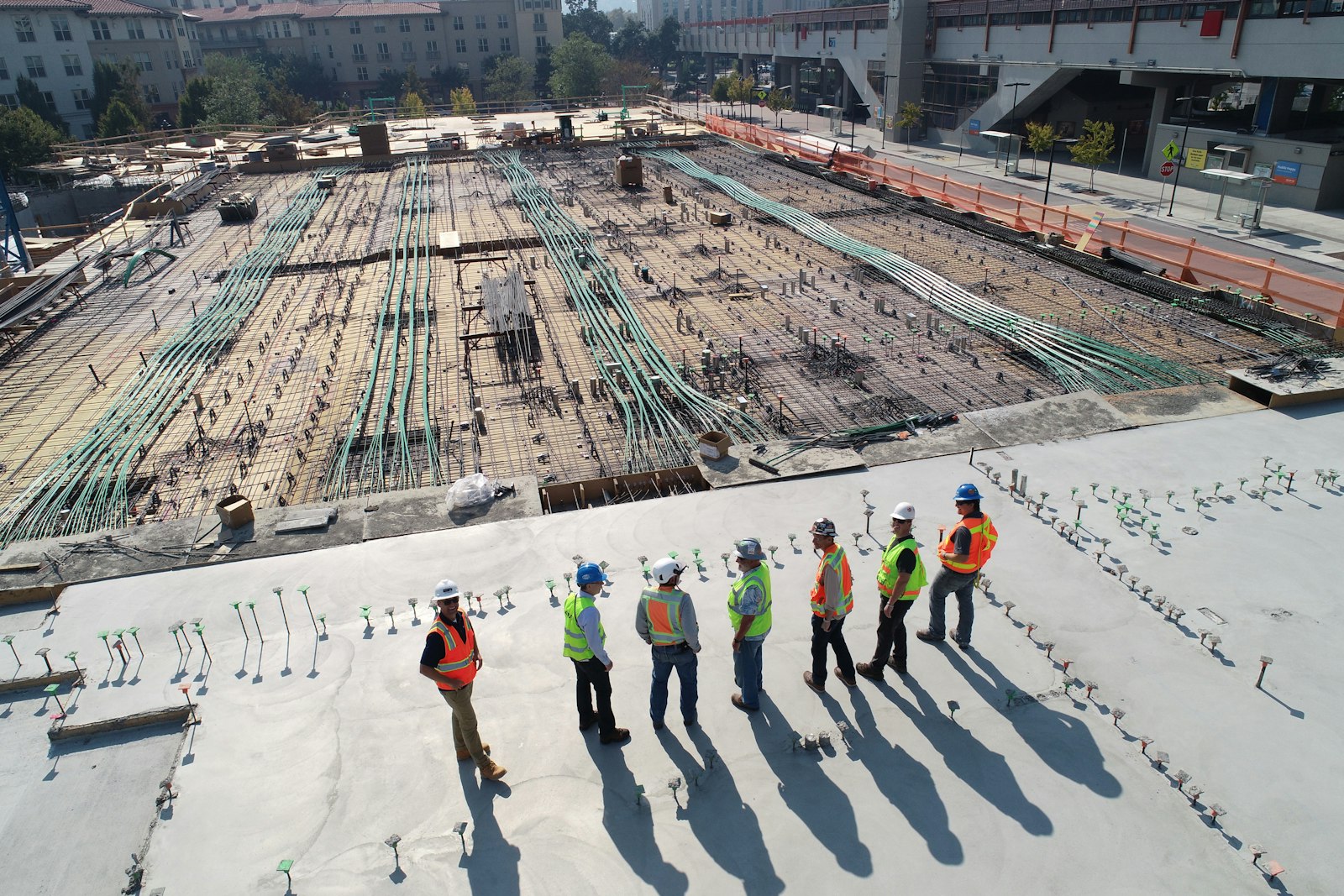 Aerial view of a structural deck pour with crew on the slab
